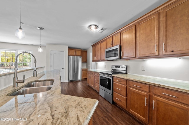 106 Waterside Dr, Bath, NC 27808 - kitchen featuring appliances with stainless steel finishes, a sink, brown cabinets, dark wood-type flooring, and hanging light fixtures