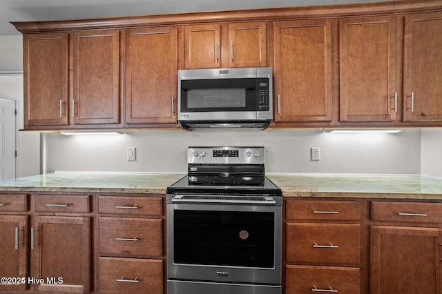 106 Waterside Dr, Bath, NC 27808 - kitchen with appliances with stainless steel finishes, brown cabinetry, and light stone countertops
