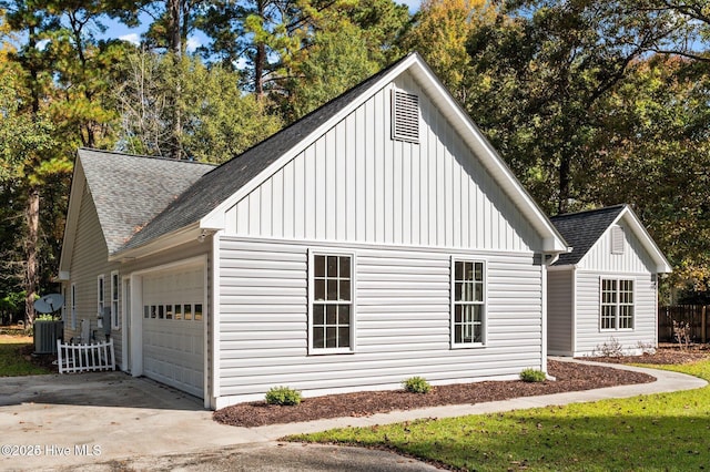 106 Waterside Dr, Bath, NC 27808 - view of side of property featuring roof with shingles, board and batten siding, an attached garage, and driveway