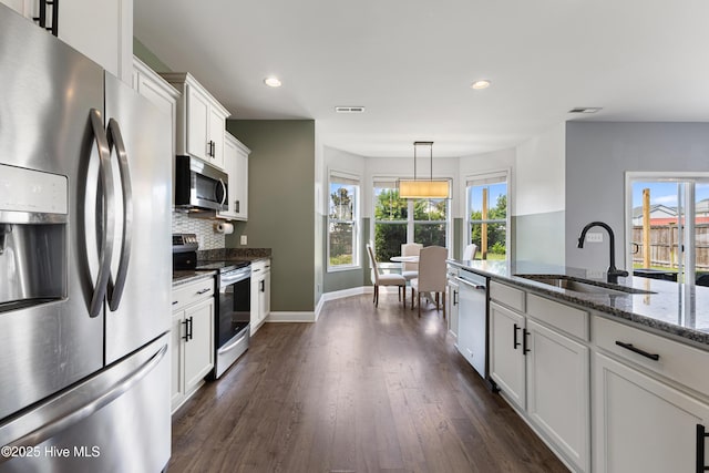 737 Heartwood Dr, Leland, NC 28479 - kitchen with appliances with stainless steel finishes, a sink, dark wood-style flooring, recessed lighting, and white cabinetry