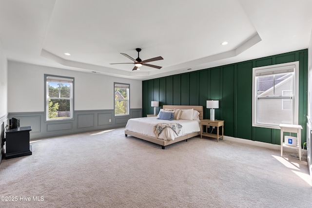 737 Heartwood Dr, Leland, NC 28479 - bedroom with a decorative wall, a raised ceiling, light carpet, ceiling fan, and recessed lighting