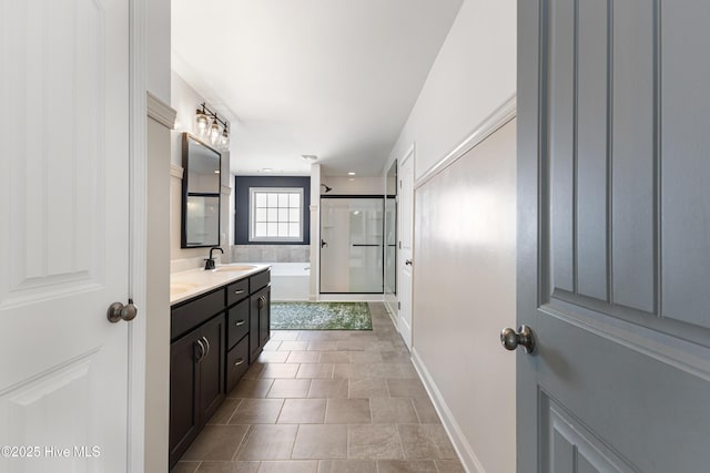737 Heartwood Dr, Leland, NC 28479 - bathroom with vanity, a shower stall, a bath, and baseboards