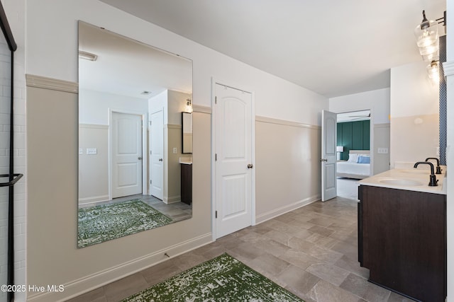 737 Heartwood Dr, Leland, NC 28479 - bathroom featuring vanity, stone finish flooring, and baseboards