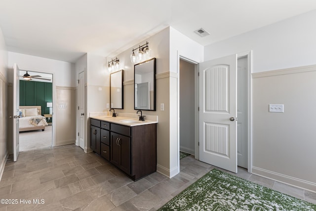 737 Heartwood Dr, Leland, NC 28479 - bathroom featuring ensuite bathroom, double vanity, ceiling fan, stone finish floors, and baseboards