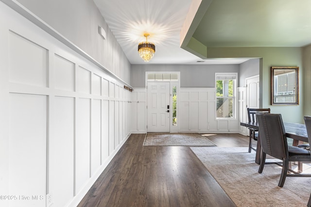 737 Heartwood Dr, Leland, NC 28479 - foyer entrance with a decorative wall, a chandelier, wood finished floors, and a wainscoted wall