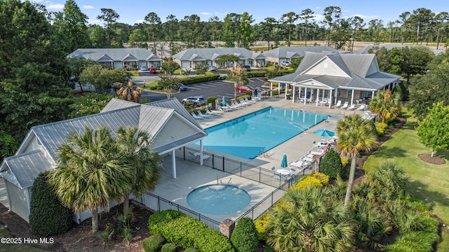737 Heartwood Dr, Leland, NC 28479 - community pool featuring a patio and view of scattered trees