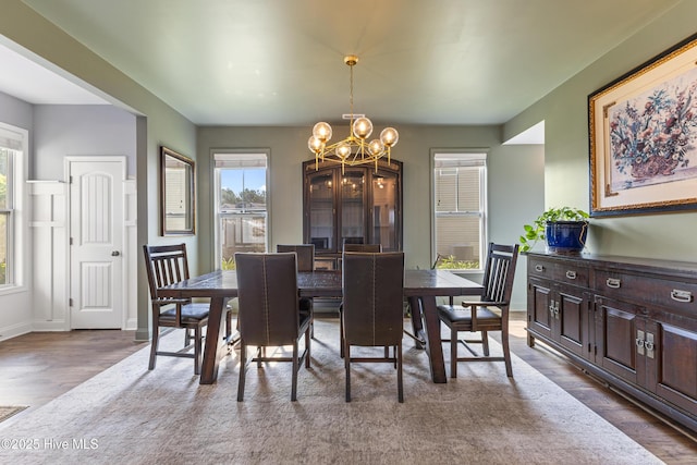 737 Heartwood Dr, Leland, NC 28479 - dining space with plenty of natural light, a chandelier, wood finished floors, and baseboards