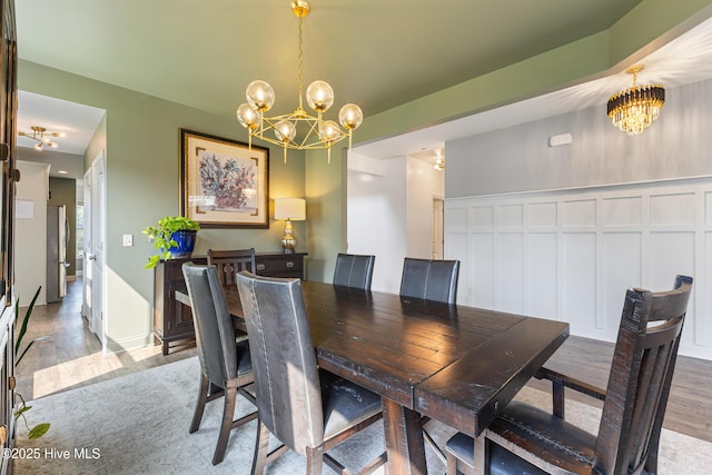 737 Heartwood Dr, Leland, NC 28479 - dining space featuring a chandelier, wood finished floors, and a decorative wall