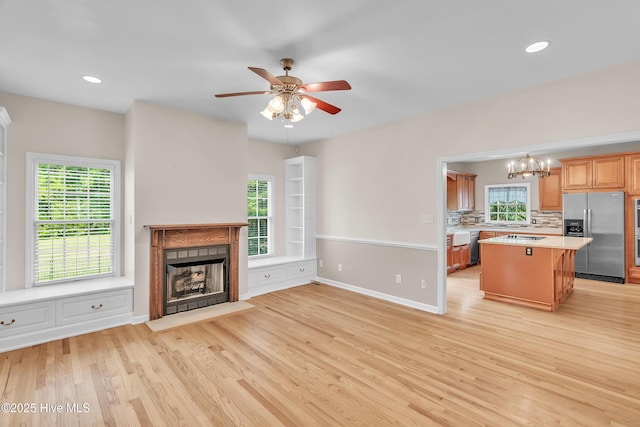 142 Magens Way, Cedar Point, NC 28584 - unfurnished living room with light wood-type flooring, a fireplace with flush hearth, a ceiling fan, plenty of natural light, and recessed lighting