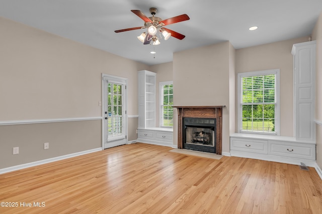 142 Magens Way, Cedar Point, NC 28584 - unfurnished living room featuring a fireplace with flush hearth, light wood finished floors, ceiling fan, baseboards, and recessed lighting