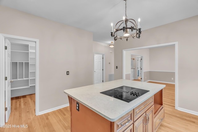142 Magens Way, Cedar Point, NC 28584 - kitchen with black electric stovetop, light wood finished floors, light countertops, a chandelier, and baseboards