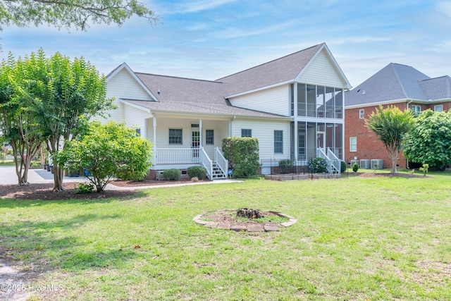 142 Magens Way, Cedar Point, NC 28584 - traditional-style house featuring a sunroom, a front lawn, a porch, roof with shingles, and stairs