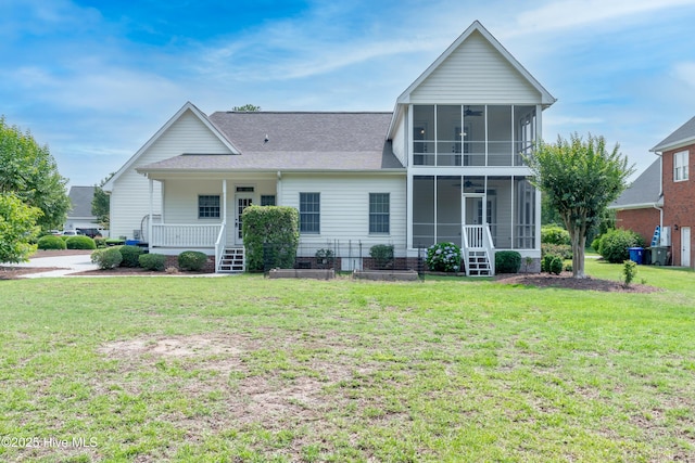 142 Magens Way, Cedar Point, NC 28584 - rear view of house with a sunroom, a lawn, and roof with shingles