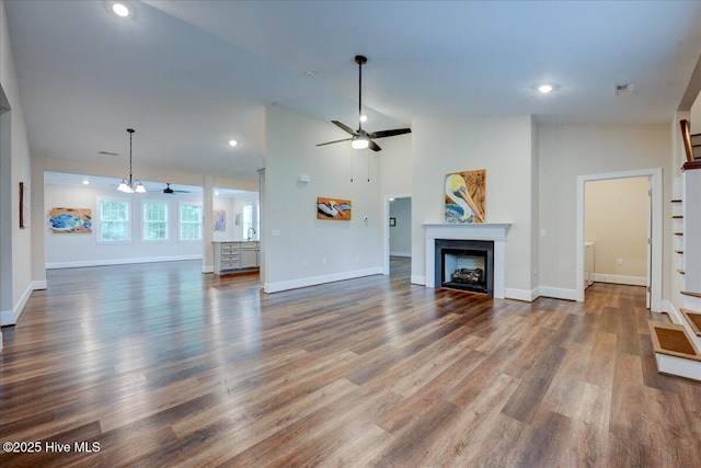 409 Kinnakeet Ln, New Bern, NC 28562 - unfurnished living room featuring a ceiling fan, a fireplace, baseboards, dark wood finished floors, and recessed lighting