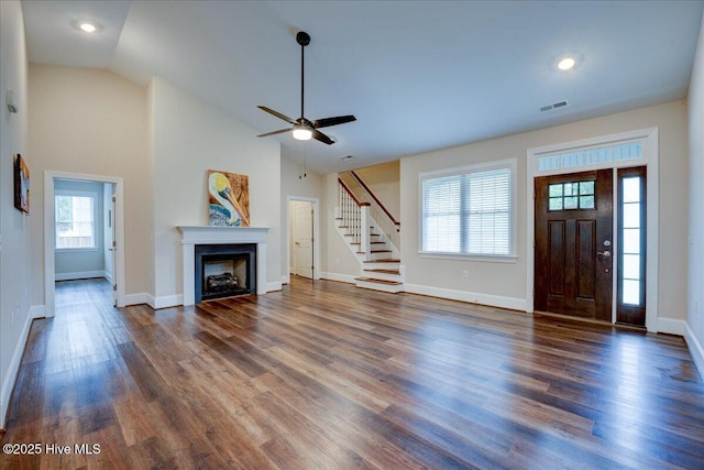 409 Kinnakeet Ln, New Bern, NC 28562 - unfurnished living room featuring stairs, ceiling fan, vaulted ceiling, plenty of natural light, and wood finished floors