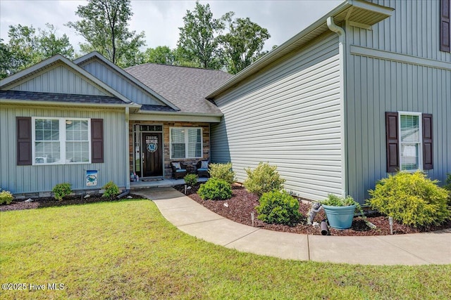 409 Kinnakeet Ln, New Bern, NC 28562 - view of front facade featuring a front yard, board and batten siding, and a shingled roof