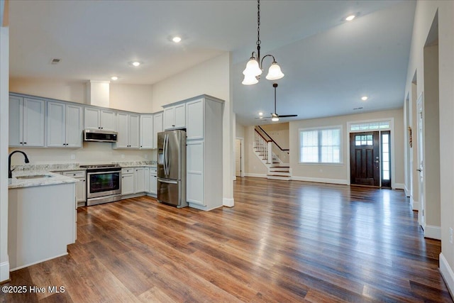 409 Kinnakeet Ln, New Bern, NC 28562 - kitchen with stainless steel appliances, a sink, open floor plan, baseboards, and light stone counters