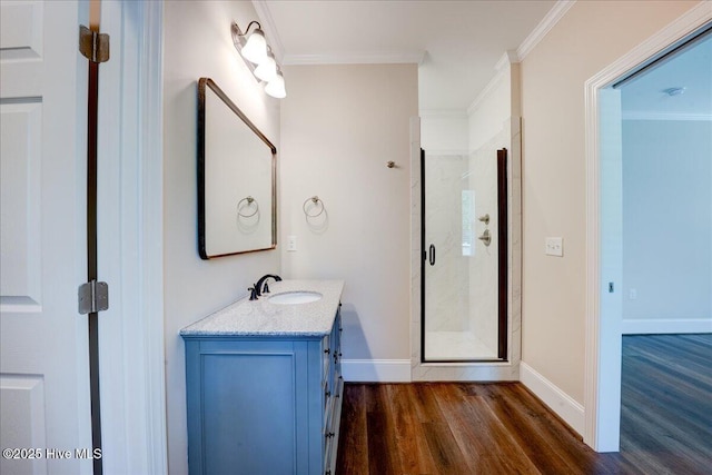 409 Kinnakeet Ln, New Bern, NC 28562 - full bath featuring wood finished floors, vanity, a shower stall, baseboards, and ornamental molding