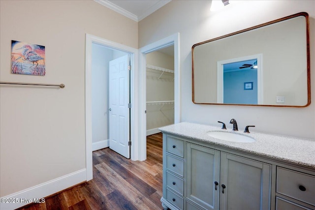 409 Kinnakeet Ln, New Bern, NC 28562 - bathroom featuring crown molding, vanity, wood finished floors, and baseboards