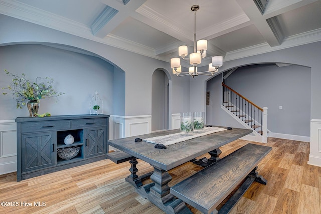 1279 Pandion Dr, Wilmington, NC 28411 - dining area with coffered ceiling, arched walkways, a chandelier, stairs, and beamed ceiling