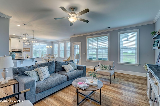1279 Pandion Dr, Wilmington, NC 28411 - living area featuring light wood-type flooring, ornamental molding, a chandelier, a ceiling fan, and baseboards