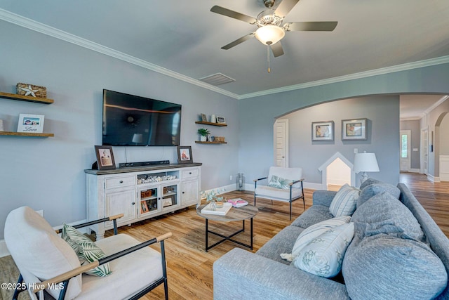 1279 Pandion Dr, Wilmington, NC 28411 - living area featuring arched walkways, crown molding, light wood finished floors, a ceiling fan, and baseboards