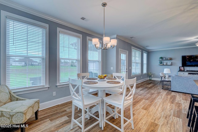1279 Pandion Dr, Wilmington, NC 28411 - dining area with a chandelier, light wood finished floors, baseboards, and ornamental molding