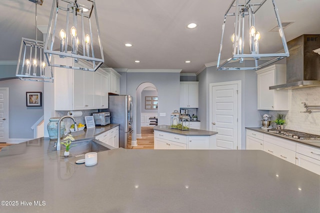 1279 Pandion Dr, Wilmington, NC 28411 - kitchen with a chandelier, a sink, dark countertops, stainless steel appliances, and wall chimney exhaust hood