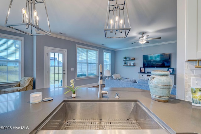 1279 Pandion Dr, Wilmington, NC 28411 - kitchen with open floor plan, a sink, a ceiling fan, ornamental molding, and a chandelier