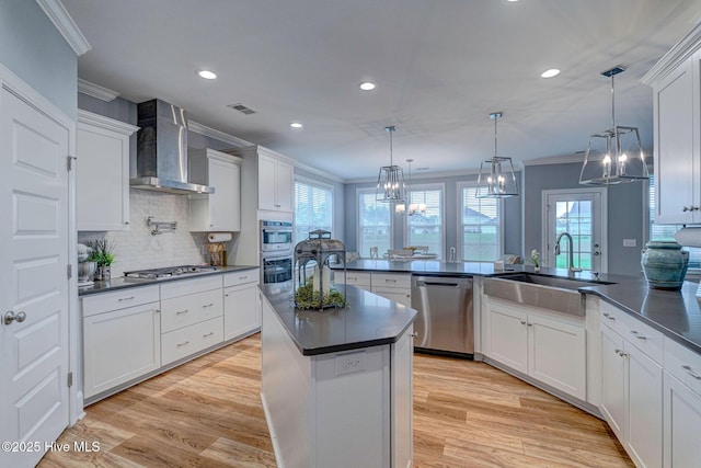 1279 Pandion Dr, Wilmington, NC 28411 - kitchen featuring appliances with stainless steel finishes, wall chimney exhaust hood, dark countertops, crown molding, and recessed lighting