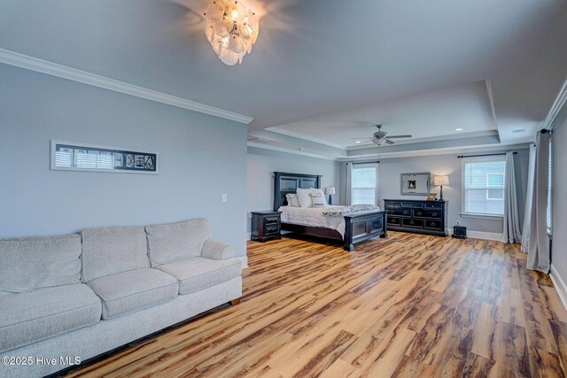 1279 Pandion Dr, Wilmington, NC 28411 - bedroom featuring a tray ceiling, wood finished floors, crown molding, and baseboards