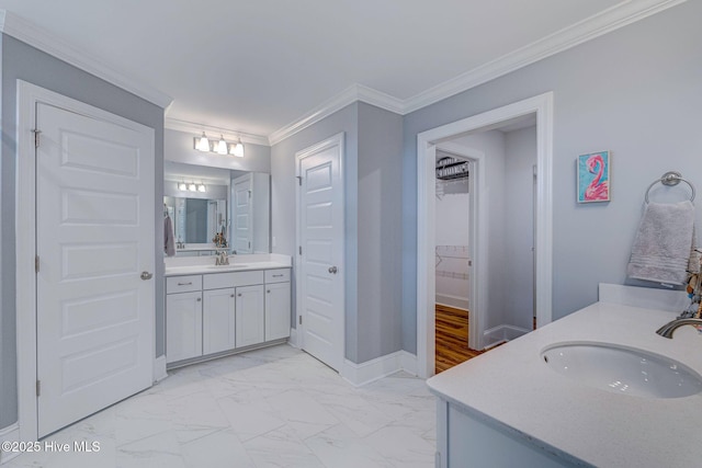 1279 Pandion Dr, Wilmington, NC 28411 - bathroom featuring marble look tile flooring, two vanities, ornamental molding, baseboards, and a spacious closet