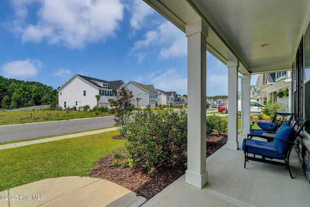 1279 Pandion Dr, Wilmington, NC 28411 - covered porch with a residential view and a lawn