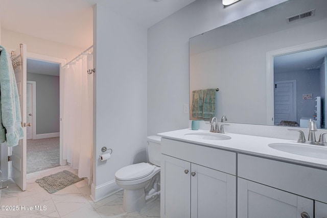 1279 Pandion Dr, Wilmington, NC 28411 - bathroom featuring double vanity, marble look tile flooring, toilet, and baseboards