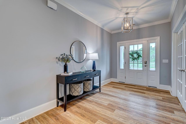 1279 Pandion Dr, Wilmington, NC 28411 - entryway with light wood-style floors, baseboards, crown molding, and a chandelier