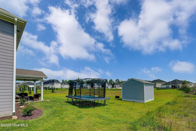 1279 Pandion Dr, Wilmington, NC 28411 - view of green lawn featuring a trampoline, a residential view, and a patio area