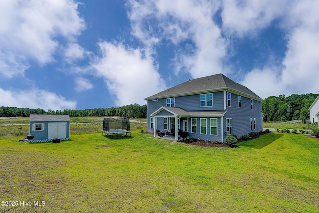 1279 Pandion Dr, Wilmington, NC 28411 - back of property featuring a trampoline, a patio area, and a lawn