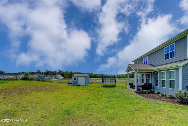 1279 Pandion Dr, Wilmington, NC 28411 - view of grassy yard with a trampoline and a patio area