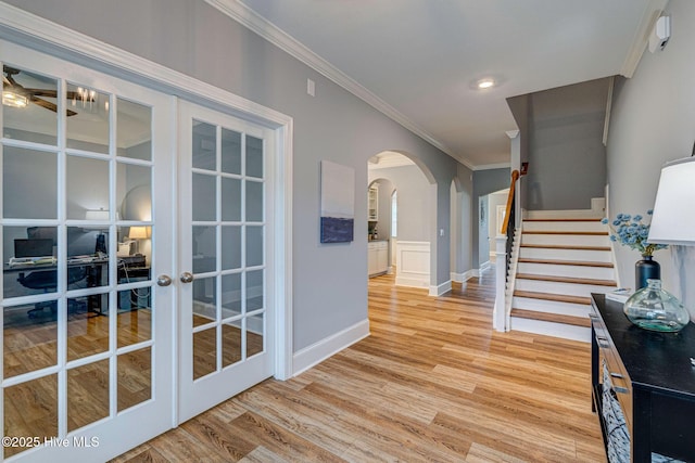 1279 Pandion Dr, Wilmington, NC 28411 - foyer featuring arched walkways, french doors, crown molding, light wood-style floors, and stairway