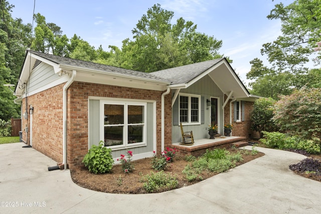 109 Dilworth Rd, Wilmington, NC 28411 - view of front facade with brick siding, a shingled roof, and driveway