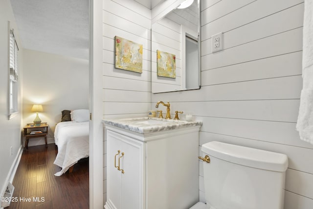 109 Dilworth Rd, Wilmington, NC 28411 - bathroom featuring vanity, toilet, wood finished floors, wood walls, and ensuite bathroom