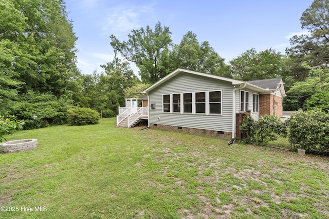 109 Dilworth Rd, Wilmington, NC 28411 - back of house featuring crawl space, a lawn, stairway, and a fire pit