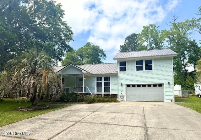 3670 Earls Rd, Myrtle Beach, SC 29588 - view of front of property featuring an attached garage, covered porch, concrete driveway, and metal roof