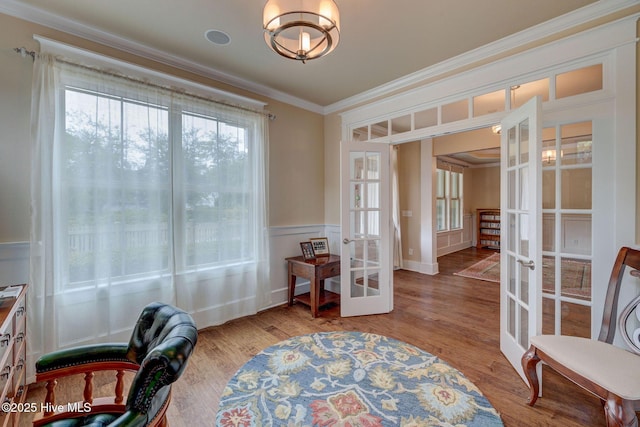 7406 Songbird Ct, Wilmington, NC 28411 - living area with french doors, crown molding, wood finished floors, and wainscoting