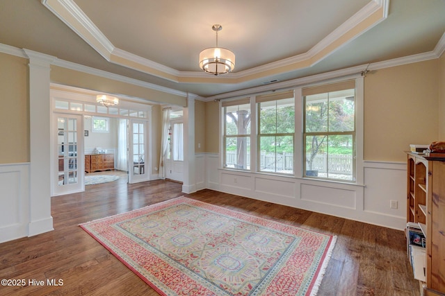 7406 Songbird Ct, Wilmington, NC 28411 - foyer entrance with a tray ceiling, wainscoting, crown molding, a decorative wall, and french doors