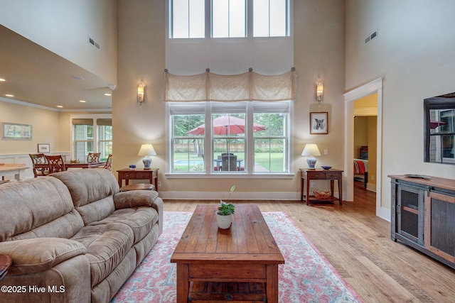 7406 Songbird Ct, Wilmington, NC 28411 - living room with a towering ceiling, light wood finished floors, recessed lighting, and baseboards