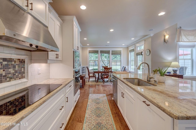7406 Songbird Ct, Wilmington, NC 28411 - kitchen featuring a sink, under cabinet range hood, appliances with stainless steel finishes, wood finished floors, and white cabinets