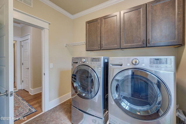 7406 Songbird Ct, Wilmington, NC 28411 - washroom featuring cabinet space, washing machine and clothes dryer, ornamental molding, and baseboards