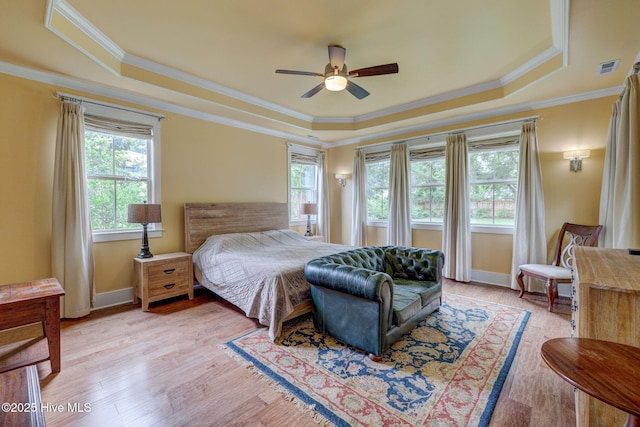 7406 Songbird Ct, Wilmington, NC 28411 - bedroom with a tray ceiling, ornamental molding, light wood-style floors, baseboards, and ceiling fan