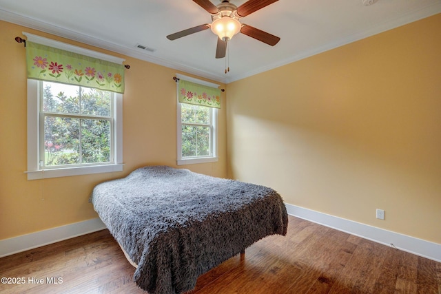 7406 Songbird Ct, Wilmington, NC 28411 - bedroom with baseboards, wood finished floors, crown molding, and ceiling fan
